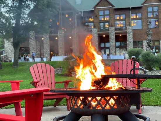 A bonfire burns brightly behind the Grand Lodge at Heartwood Resort near Trego, Wis.