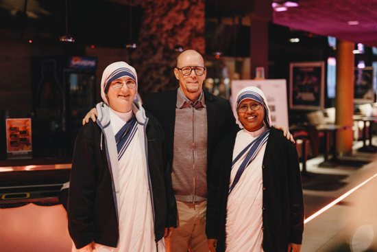 James Wahlberg, producer of "Mother Teresa: No Greater Love" poses with Sister Szymona and Sister Jose Mercy of the Missionaries of Charity at the documentary's premiere in Radom, Poland, Oct. 19, 2023. Wahlberg, brother of Hollywood actor Mark Wahlberg, was serving time in prison as a convicted drug addict when when Mother Teresa paid a visit in 1988 and changed his life.