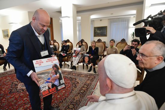 Pope Francis meets relatives of hostages taken by Hamas militants from Israel Oct. 7 in his residence, the Domus Sanctae Marthae, at the Vatican Nov. 22, 2023. Members of the delegation carried posters of their loved ones.