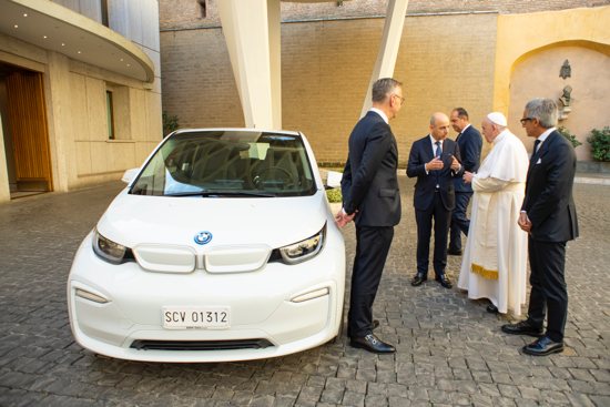 Pope Francis speaks with representatives from BMW Italia at the Vatican Sept. 22, 2021. The German car company donated an all-electric zero emissions BMW i3 to the pope to support efforts toward environmental sustainability.