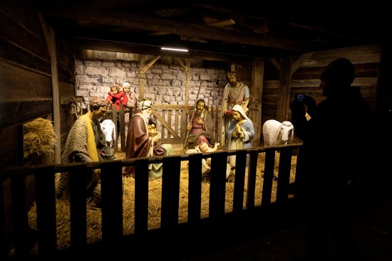 A person takes a cellphone photo of a Nativity scene in the Viennese Christmas Market at City Hall Square in Vienna Dec. 6, 2022.