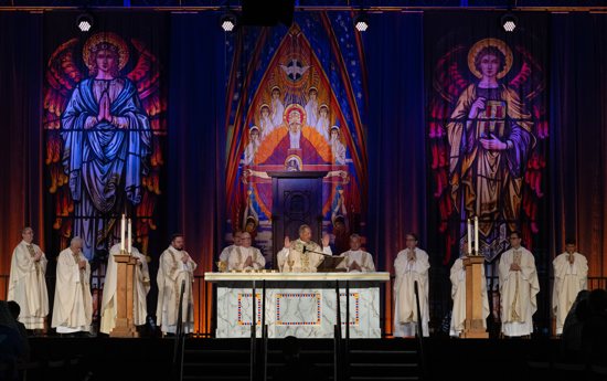 Bishop Oscar A. Solis of Salt Lake City and clergy from the diocese celebrate the Liturgy of the Eucharist during Mass July 9, 2023, at the Mountain America Expo Center in Sandy, Utah. An estimated 10,000 people from throughout Utah attended the Eucharistic Rally and Mass, which was the culmination of the diocese's "Year of Diocesan Revival."