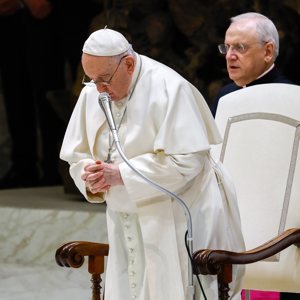Pope Francis prays during his general audience in the Paul VI Audience Hall at the Vatican Dec. 27, 2023.