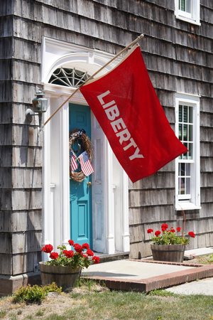A Revolutionary War "Liberty" flag is seen outside a home in Setauket, N.Y., June 24, 2020. The U.S. Conference of Catholic Bishops' first annual "State of Religious Liberty in the United States," published Jan. 16, 2024, identifies five top threats to religious liberty in the United States, including a federal regulation it says could impose mandates on doctors to perform objectionable procedures and threats to the church's service to people who are migrants.