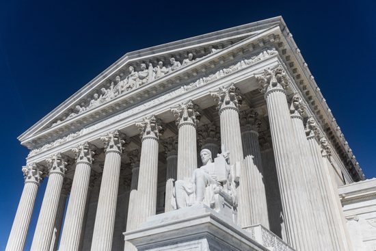 In this undated file photo, James Earle Fraser's statue "The Authority of Law" sits at the entrance to the U.S. Supreme Court in Washington.