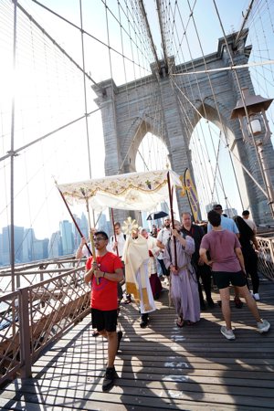 Bishop Robert J. Brennan of Brooklyn, N.Y., carries the monstrance while leading a Eucharistic procession across the Brooklyn Bridge to Brooklyn from Manhattan on the National Eucharistic Pilgrimage's Seton (East) Route May 26, 2024.