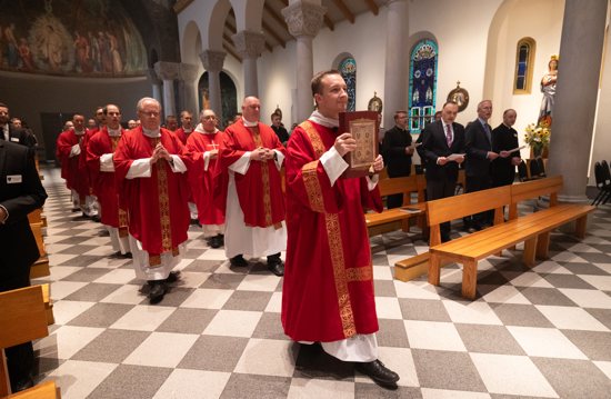 Deacon Ryan Sustacek carries the Book of the Gospels in the processional of the annual kickoff Mass at The St. Paul Seminary Sept. 6, 2023.