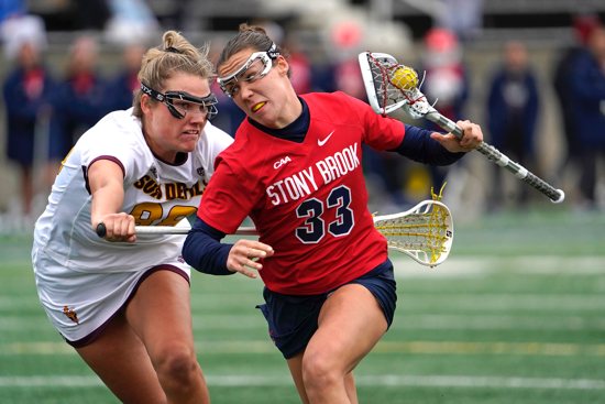 Stony Brook's Courtney Maclay maintains possession of the ball against Arizona State's Zoe Mazur during an NCAA women's lacrosse game in Stony Brook, N.Y., Feb. 23, 2024. The Supreme Court Aug. 16 temporarily blocked a Biden administration rule to expand Title IX's prohibition on sex discrimination to include sexual orientation and gender identity. The 1972 federal civil rights law requires that women and girls have equal access and treatment in education and athletics.