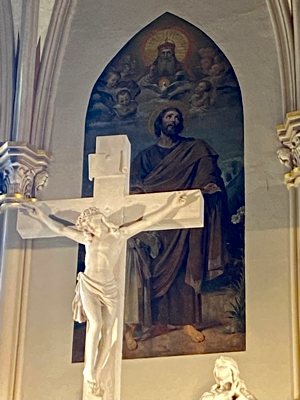 A painting of St. Joseph is visible directly behind a sculpture of Christ on the cross in the sanctuary of St. Joseph in Mishawka, Indiana. 