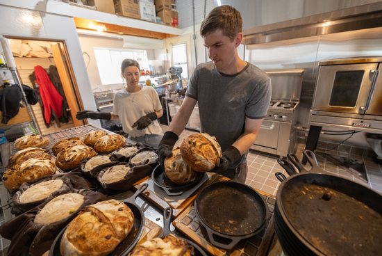 Baking:Jake Kappers takes part in the bread baking process Sept. 11, working alongside his now-wife. 
