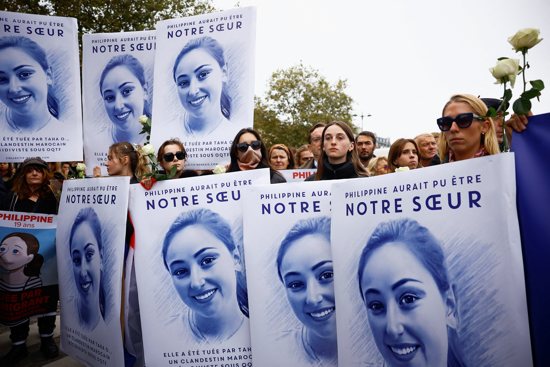 People gather at the Place Denfert Rochereau in Paris Sept. 29, 2024, in honor of a young Catholic student, Philippine de Carlan, whose body was found half-buried in the city's Bois de Boulogne area and whom police suspect was murdered by a 22-year-old Moroccan man. Placards held by women with a feminist group called Nemesis reads, "Philippine could have been our sister."