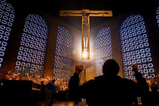 A person prays during a Mass to celebrate the feast of Our Lady of Aparecida at the Basilica of the National Shrine of Our Lady of Aparecida in São Paulo Oct. 12, 2021.