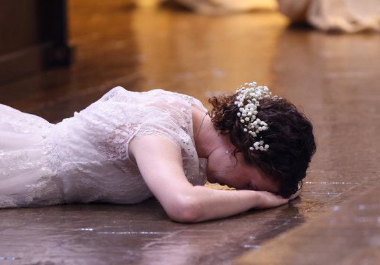 Karen Bless lies prostrate before the altar during a Mass for her consecration to the "Ordo Virginum," the Order of Virgins, celebrated by Dallas Auxiliary Bishop Greg Kelly at the Church of the Incarnation on the campus of the University of Dallas June 22, 2024.