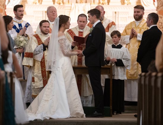 Bridgette and Jake Kappers exchange wedding vows at St. Mary in Chatfield Sept. 14. At center is the principal celebrant, Father Bryce Evans, co-pastor of St. Mary in downtown St. Paul. Also from the Archdiocese of St. Paul and Minneapolis are Father Francis Floeder, back left, Deacon Alexander Marquette, front left, and Father Kyle Etzel, back right.
