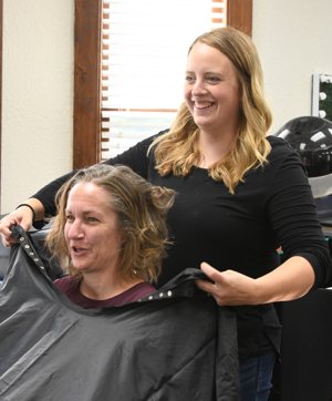 Maria Heinen styles a co-worker's hair in her salon, Styles Plus Salon and Spa in Cold Spring, Minn., Sept. 11, 2024. Heinen has been embraced by the salon community after she and her husband, Nick, lost their newborn, Jack Joseph Heinen, shortly after childbirth.