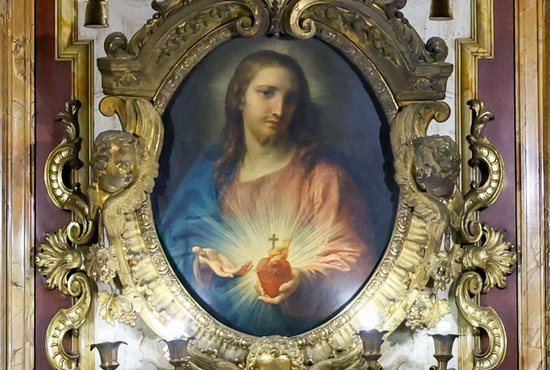 A painting by Pompeo Batoni of the Sacred Heart of Jesus from 1767 is displayed in an ornate frame inside the Jesuit Church of the Gesù in Rome, Oct. 22, 2024.