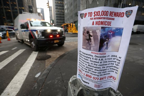  A poster is seen Dec. 5, 2024, attached to a lamp post outside the Hilton hotel near the scene where the CEO of UnitedHealthcare Brian Thompson was ambushed and shot dead the day before in New York City's midtown Manhattan neighborhood. 