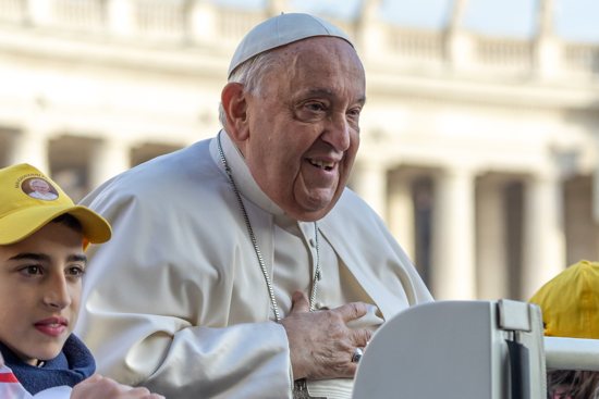 Pope Francis greets visitors as he rides the popemobile around St. Peter's Square before his weekly general audience at the Vatican Nov. 27, 2024.
