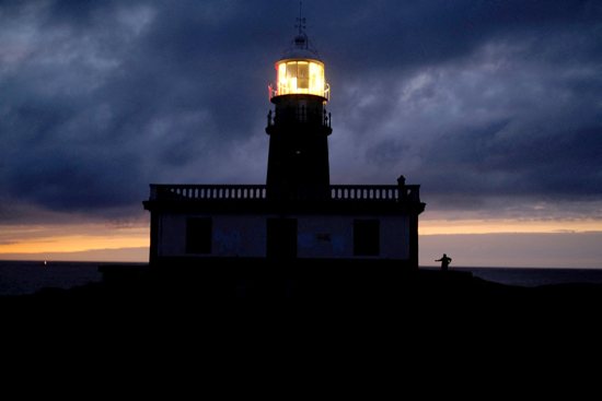 A pilgrim stands near the Corrubedo lighthouse Oct. 2, 2023, as he continues his pilgrimage on El Camino de Santiago, or the Way of St. James, near Ribeira, Galicia, in northwestern Spain. According to the pilgrims' office in Santiago de Compostela, a record 499,239 pilgrims from all over the world walked the famed Camino in 2024.