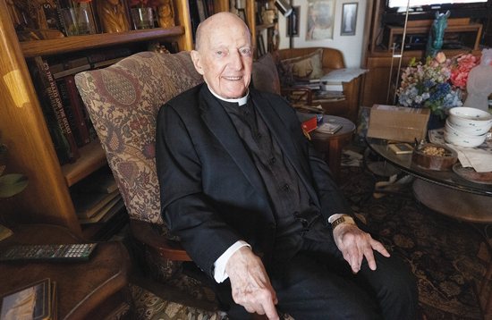 Father George Welzbacher in his room at the Leo C. Byrne Residence in St. Paul in this file photo from May 2022. An avid reader and writer of poetry, Father Welzbacher had recently put the finishing touches on a poem he had been working on for 44 years, “Galactic Shepherd.” 