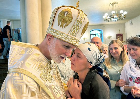 A woman speaks with Metropolitan Archbishop A. Gudziak of the Ukrainian Catholic Archeparchy of Philadelphia Sept. 8, 2024, following Divine Liturgy at St. Nicholas the Wonderworker Ukrainian Greek Catholic Church in Kharkiv, Ukraine, located within 30 miles of the frontline of Russia's 11-year invasion of that nation.