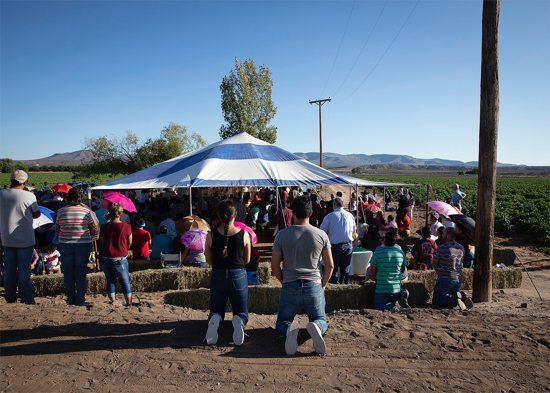 Migrant farmworkers attend an outdoor Mass Sept. 26, 2019, in Hatch, N.M. The Trump administration said Jan. 21 that it would rescind a long-standing policy preventing Immigration and Customs Enforcement agents from making arrests at what are seen as sensitive locations, including houses of worship, schools and hospitals.