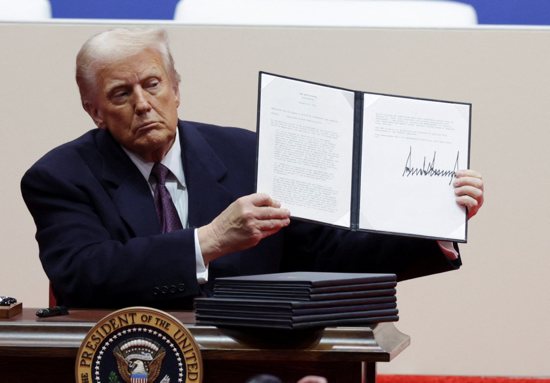 U.S. President Donald Trump shows a signed executive order during a rally inside Capital One Arena in Washington on Inauguration Day Jan. 20, 2025. Earlier in the day, he was sworn in to his second presidential term during a ceremony in the Capitol Rotunda.