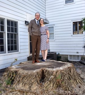 John and Dia Boyle stand on the stump of the 108-foot eastern cottonwood they had removed from their backyard last fall. 