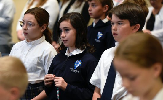 Students at Ave Maria Academy in Maple Grove listen to a presentation Oct. 3, 2024, that awarded all Catholic schools in the Archdiocese of St. Paul and Minneapolis with a certificate of Lumen Accreditation offered through The Catholic University of America in Washington, D.C. The presentation was held during a visit to the school from Catholic school leaders in the archdiocese and a team from Lumen.