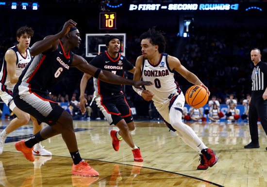 Gonzaga Bulldogs guard Ryan Nembhard (0) dribbles against Georgia Bulldogs center Somto Cyril (6) in the first half of a first round men's NCAA Division I tournament game at Intrust Bank Arena in Wichita, Kan., March 20, 2025. Gonzaga defeated Georgia 89-68 in first round of the tournament.