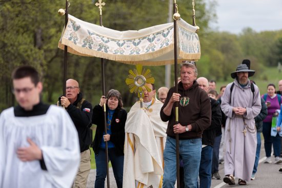 Pilgrims process from St. Theodore's Catholic Church through the town of Laporte, Minn., May 20, 2024, during the National Eucharistic Pilgrimage.