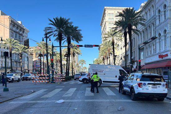 An Orleans Parish coroner's van is parked at the corner of Bourbon and Canal streets after a pickup truck drove into a large crowd in the French Quarter of New Orleans Jan. 1, 2025. A driver wrought carnage on New Orleans' famed French Quarter early on New Year's Day, ramming a pickup truck into a crowd and killing at least 15 people and injuring dozens before being shot to death by police, authorities said.