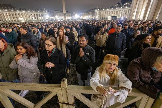 People join Cardinal Pietro Parolin, Vatican secretary of state, in reciting the rosary for Pope Francis in St. Peter's Square at the Vatican Feb. 24, 2025. Cardinals living in Rome, leaders of the Roman Curia and the faithful joined the nighttime prayer.