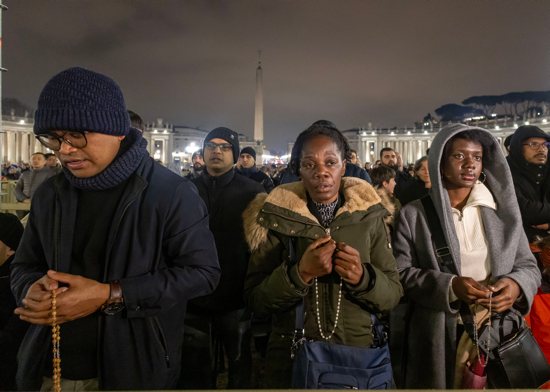 People join Cardinal Pietro Parolin, Vatican secretary of state, in reciting the rosary for Pope Francis in St. Peter's Square at the Vatican Feb. 24, 2025. Cardinals living in Rome, leaders of the Roman Curia and the faithful joined the nighttime prayer.