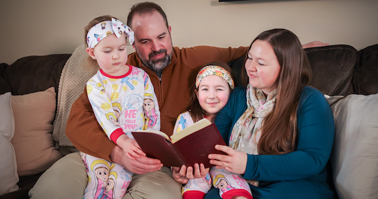 Cecilia, Luke, Genevieve and Jessica Jenkins of St. John the Baptist in Jordan read before bedtime at the Jenkins’ home in Shakopee in February.