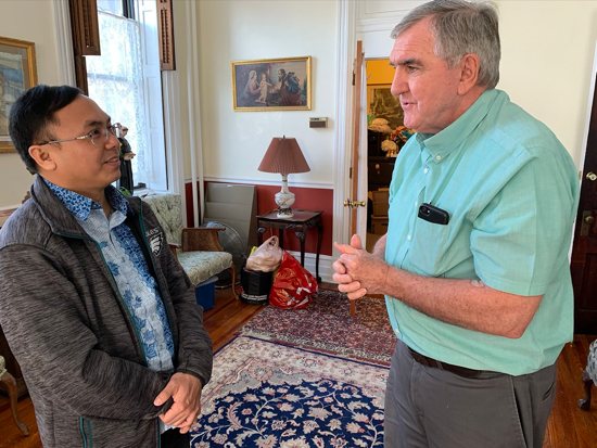 In this Jan. 16, 2020 photo, Msgr. Hugh J. Shields, then pastor of St. Thomas Aquinas Parish in Philadelphia, speaks with Vincentian Father Kurniawan Diputra, chaplain of the Philadelphia Archdiocese's Indonesian Catholic community, about U.S. immigration officers' detention of an Indonesian-Catholic couple in the parish.