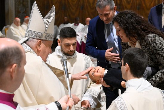 Pope Francis baptizes a baby during Mass in the Sistine Chapel at the Vatican Jan. 12, 2025, the feast of the Baptism of the Lord.