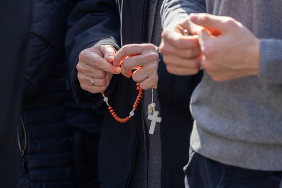People pray the rosary in the courtyard outside Rome's Gemelli hospital Feb. 23, 2025, where Pope Francis is being treated for double pneumonia.