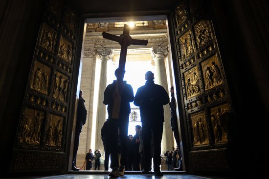 Pilgrims pass through the Holy Door of St. Peter’s Basilica on Christmas Day, Dec. 25, 2024, after it was opened by Pope Francis during Christmas Mass the night prior to mark the start of the Holy Year 2025.