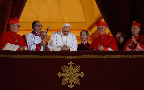 Pope Francis bows his head in prayer during his election night appearance on the central balcony of St. Peter's Basilica at the Vatican March 13, 2013. The crowd joined the pope in silent prayer after he asked them to pray that God would bless him. 