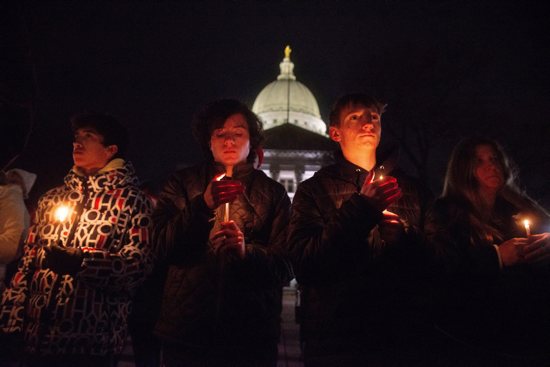 Mourners gather for a candlelight vigil at the Wisconsin State Capitol building in Madison, Wis., Dec. 17, 2024, a day after a shooting at Abundant Life Christian School in Madison. A teacher and a student were killed in the Dec. 16 morning attack at the private Christian school. Several others were injured, including two who have life-threatening injuries, according to authorities.