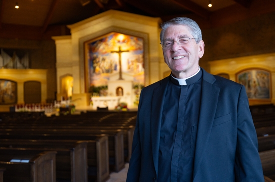 Father Thomas Dufner, pastor of Epiphany, stands inside the newly renovated church.