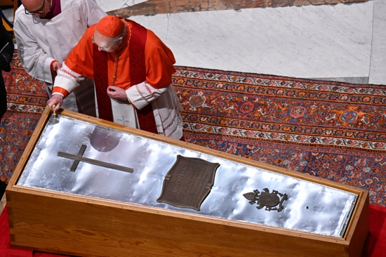 U.S. Cardinal Kevin J. Farrell, chamberlain of the Holy Roman Church, places a seal on the zinc cover of Pope Francis' casket as it is sealed during a prayer service in St. Peter's Basilica at the Vatican April 25, 2025.