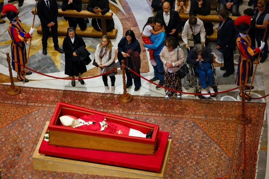 Mourners pay their respects as the body of Pope Francis lies in an open casket in front of the Altar of the Confession in St. Peter's Basilica at the Vatican April 23, 2025. The pope, who died April 21 at age 88, will lie in state for three days of public viewing and prayer ahead of his funeral Mass April 26.