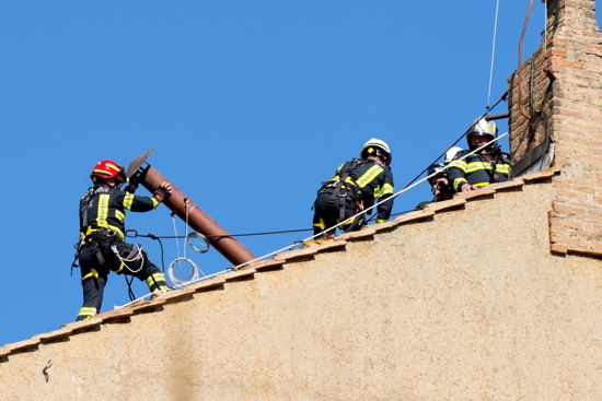 A Vatican firefighter helps install a chimney on the roof of the Sistine Chapel at the Vatican May 2, 2025. Connected to a stove in the chapel where the ballots will be burned during the conclave to elect a new pope, the chimney will signal to the world whether a new pope has been elected.