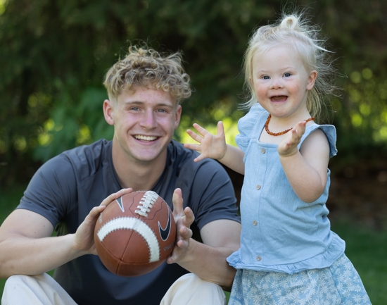 Cameron Begalle enjoys some play time with his youngest sister, Evie, in the backyard of the family’s home in Andover.