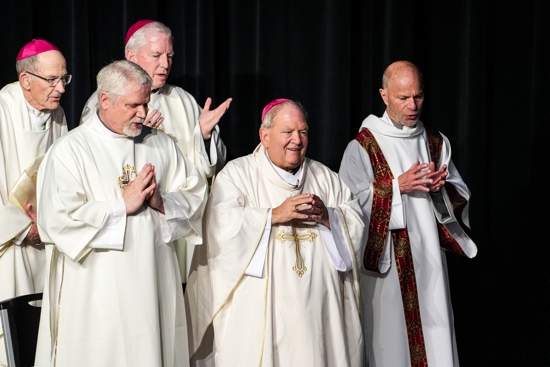 Concelebrants Bishop Emeritus John LeVoir of New Ulm, Bishop Kevin Kenney, Deacon Joe Utecht, Archbishop Bernard Hebda and Deacon Bill Heiman pray at the close of Mass in the DeLaSalle Florance Center. All but Archbishop Hebda are graduates of DeLaSalle, and the archbishop graduated from a LaSallian high school in Pittsburgh. 