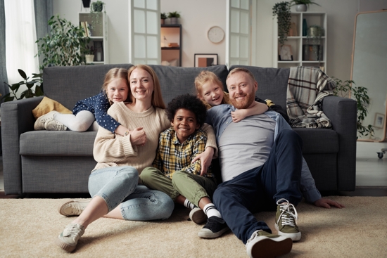 An advertisement for Catholic Charities Community Services depicts a foster care family.