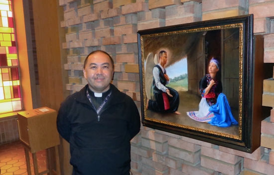 Father Toulee Peter Ly, pastor of Presentation of the Virgin Mary in Maplewood, stands beside a painting of “Hmong Mary” in the church. The painting was commissioned by Father Joseph Johnson, rector of the Cathedral of St. Paul and former pastor of St. Vincent de Paul, a former home of the Hmong Catholic community that was part of the Cathedral community.