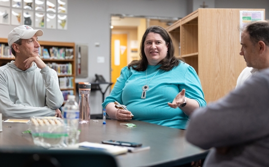 From left, Greg DeBenedetto, Christina Kraus and Brian Busch talk during their small group meeting May 28 at St. Hubert in Chanhassen. All are parishioners. DeBenedetto leads the group.